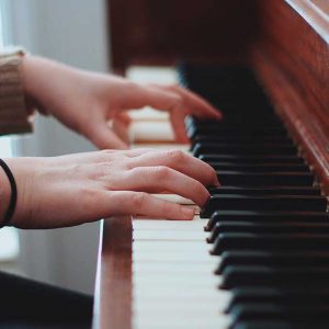 Close up of hands playing the piano